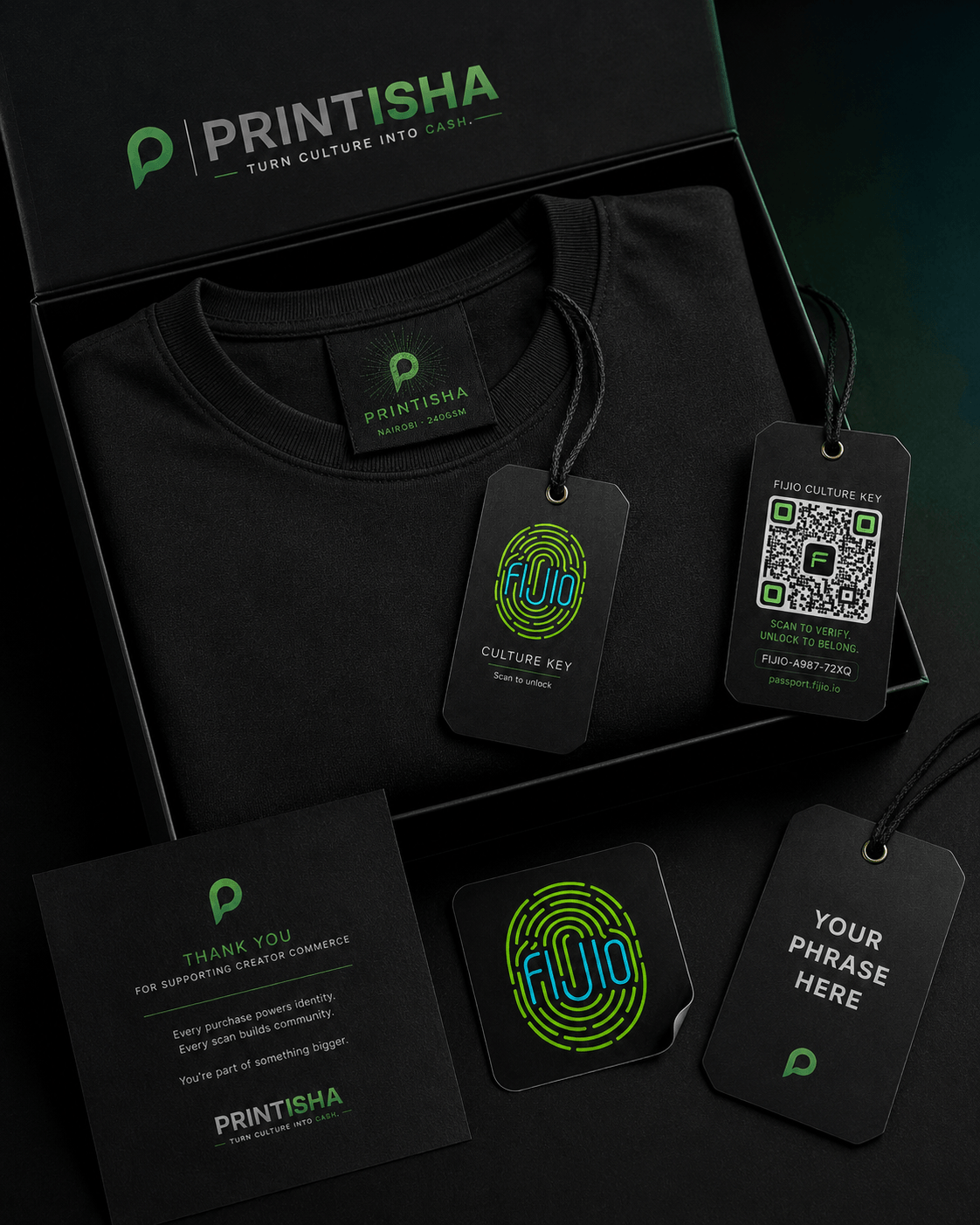 A premium Printisha drop box with a folded black tee, the woven Printisha neck label, the Fijio Culture Key hangtag and QR passport tag, a thank-you card, and a creator-phrase tag
