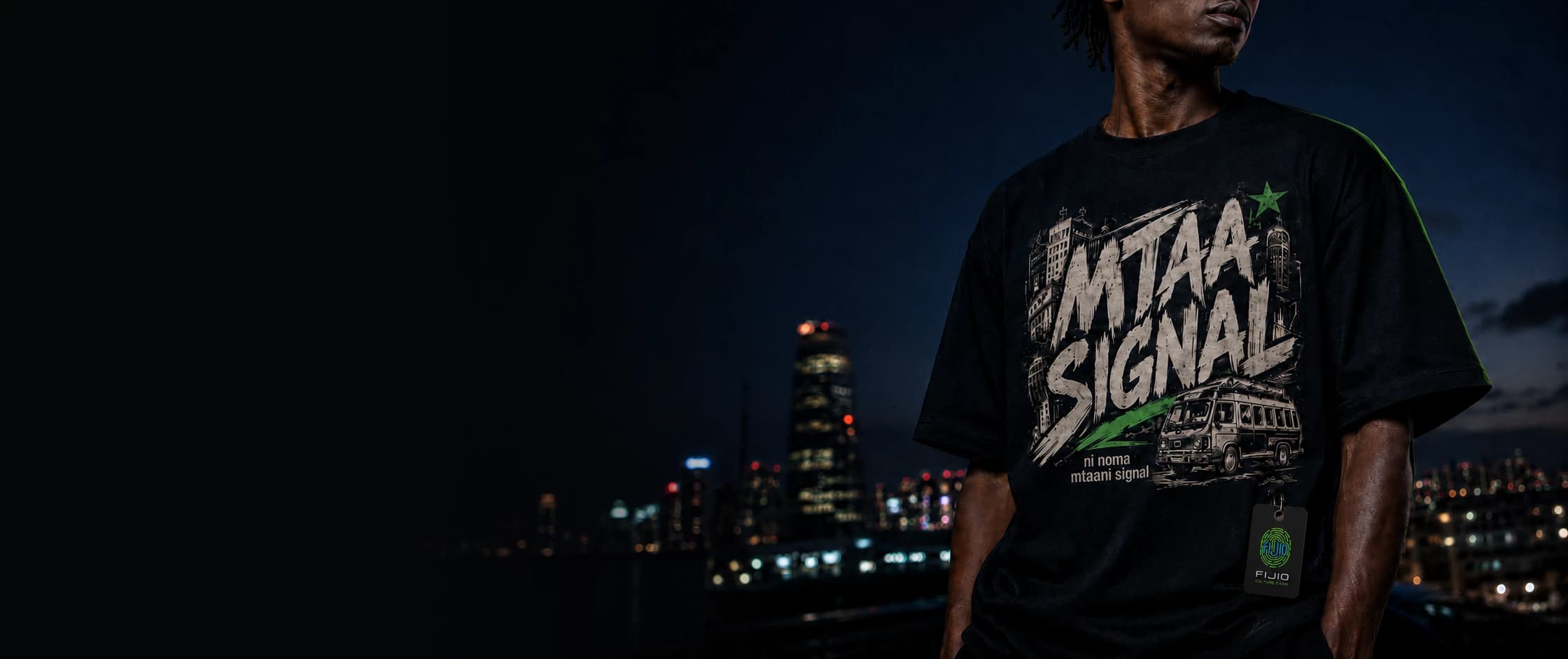 A creator on a Nairobi rooftop at night in a black MTAA SIGNAL tee with a matatu graphic and a glowing FIJIO Culture Card, city skyline behind