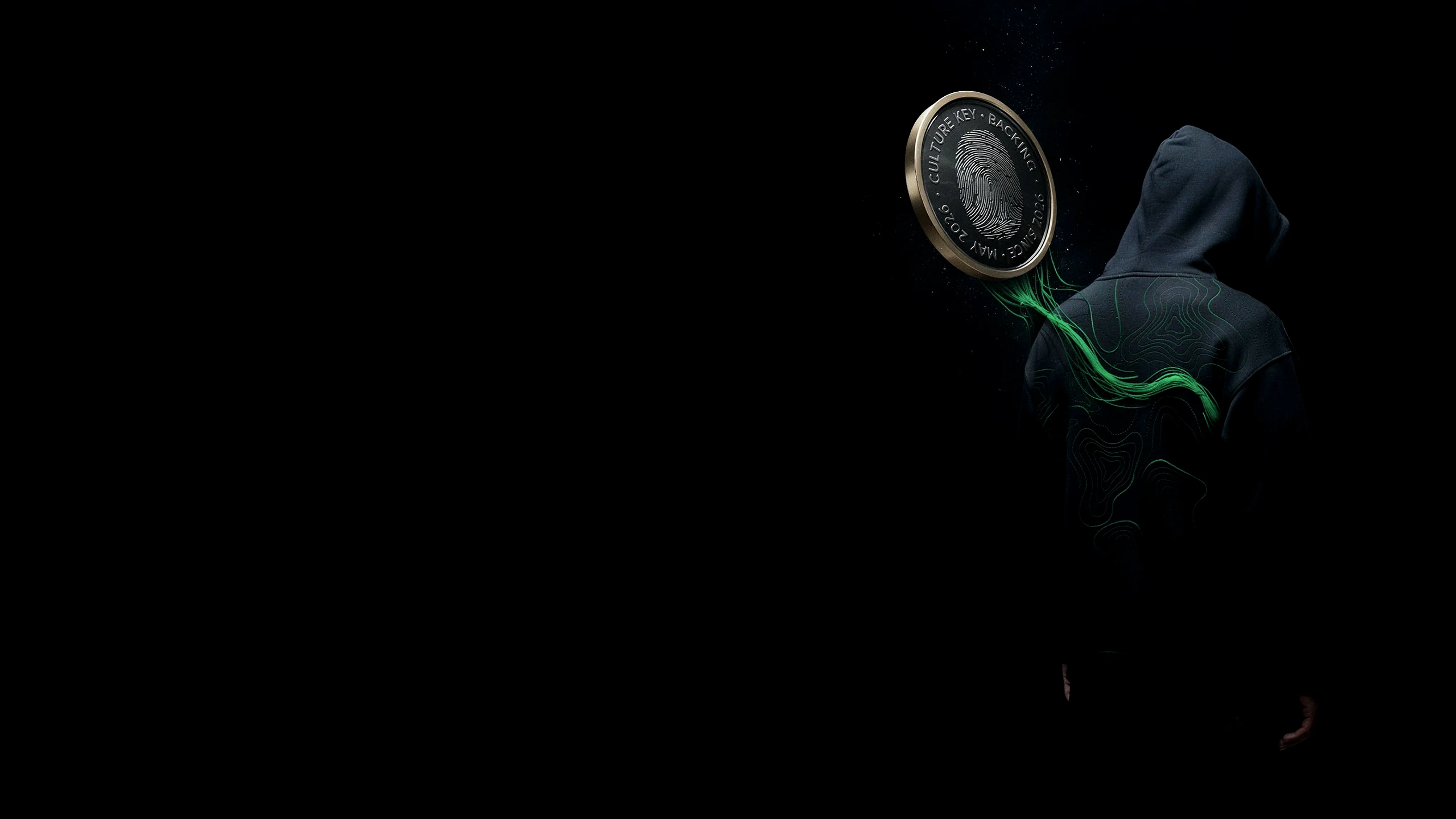 A dark hoodie with green topographic threads flowing into a stamped Culture Key backing seal
