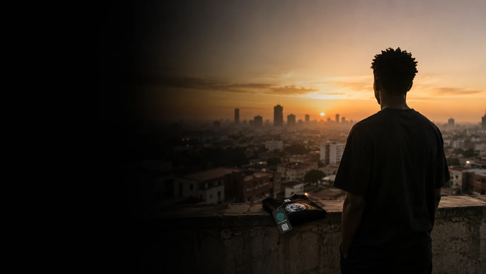 A creator seen from behind on a rooftop at golden hour, their first drop and Culture Key resting on the ledge